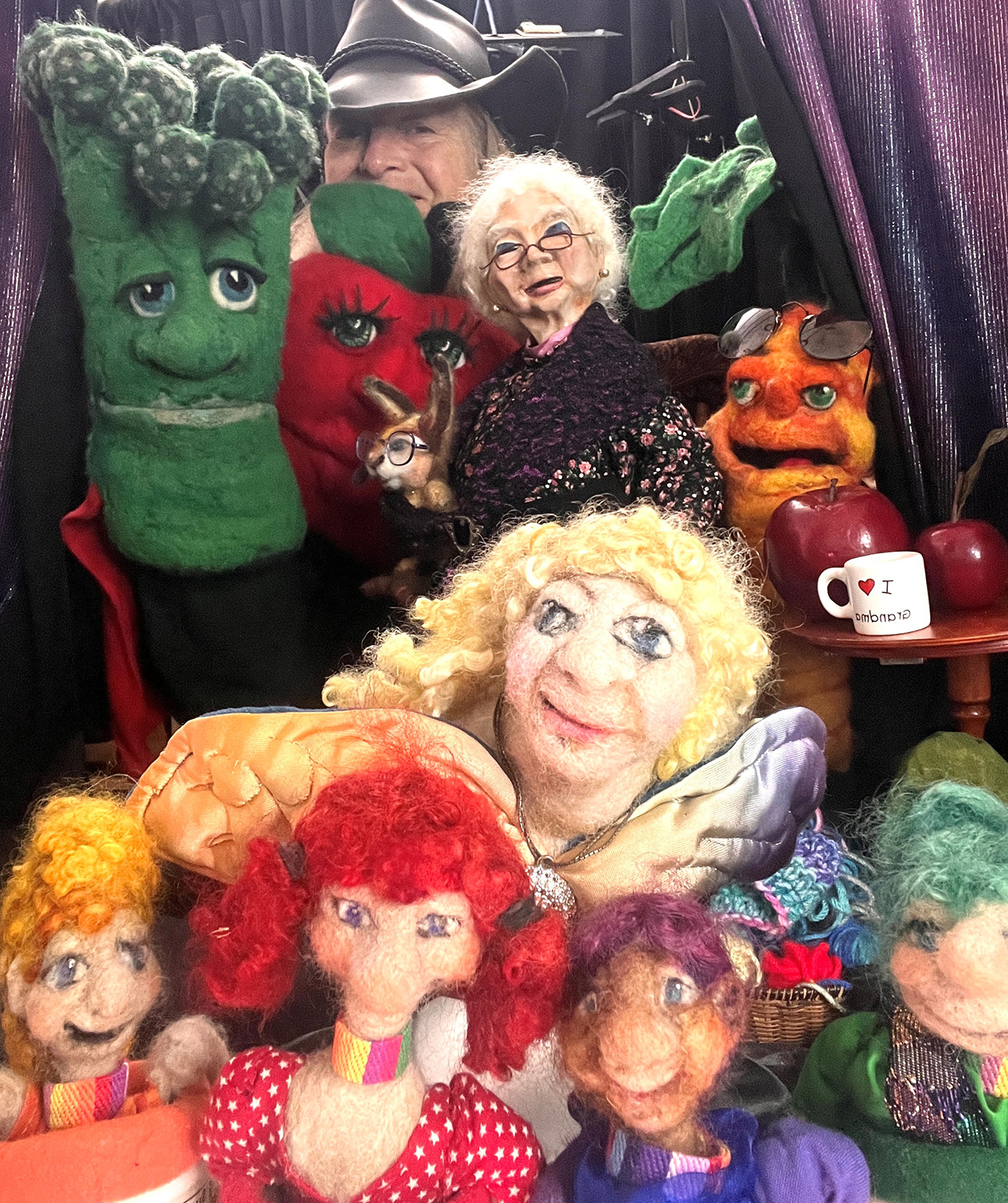 Nicol's puppets include an asparagus, a red pepper, and old lady, and a bunch of female characters 