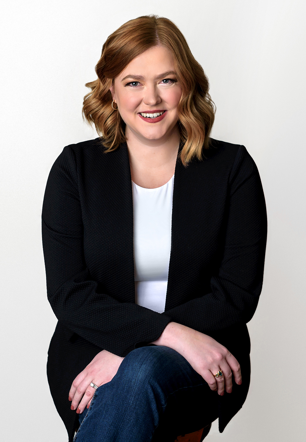 Ms. Kelly is a young Caucasian woman with shoulder-length red hair